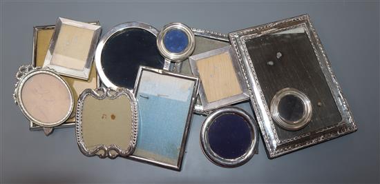 Twelve assorted small silver and white metal photograph frames.